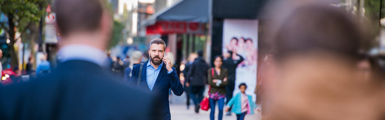 hipster-manager-with-smart-phone-walking-in-the-PFKTPR9(1) Retail & Distribution